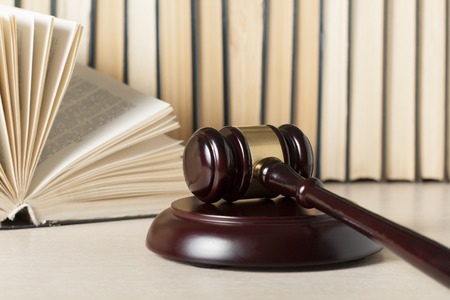Law concept. Wooden judge gavel with law books on table in a courtroom or enforcement office.の写真素材