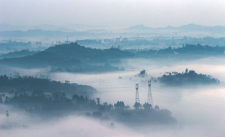 panoramic view of foggy city with electricity pylonsの写真素材