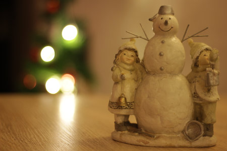 Christmas toys on the table with new year tree on backgroundの写真素材