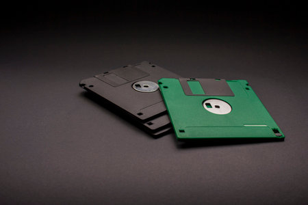 Old floppy disks on blackの写真素材