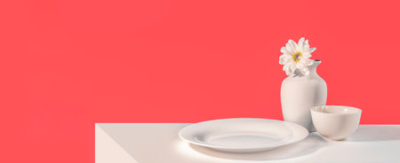 White ceramic vase with flowers on white table and red wall backgroundの写真素材