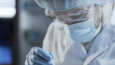 Medical scientist stirring and mixing reagents to get homogeneous consistency