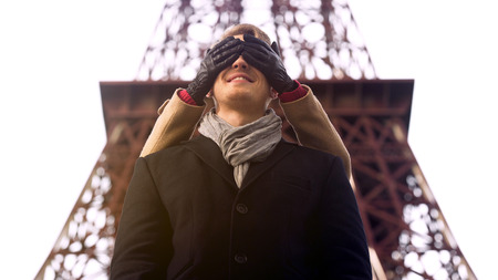 Girl taking beloved boyfriend by surprise on date, closing his eyes from behindの写真素材