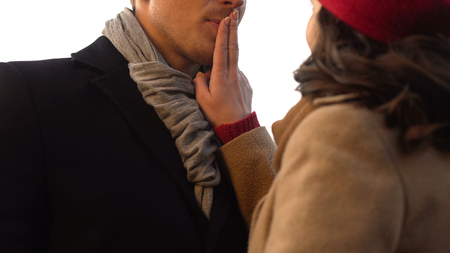 Woman playfully shuts up her boyfriend mouth, moment before kiss, romantic date, stock footageの写真素材