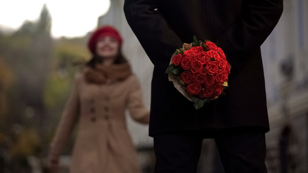 Man waiting for girlfriend, holding flowers, first date, beginning of relations, stock footageの写真素材