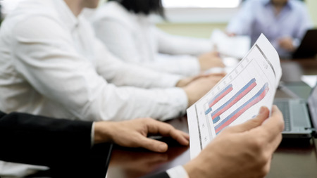Company workers discussing report documents on table, business meeting in firm, stock footage