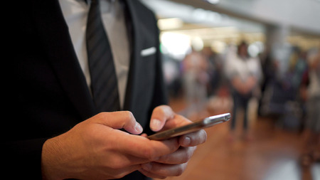 Person in business suit texting on smartphone, gadgets, modern technologiesの写真素材