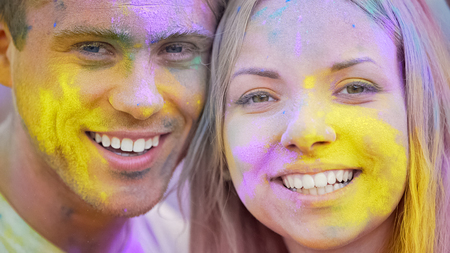 Happy smiling faces, joyful young people looking camera closeup, color festivalの写真素材
