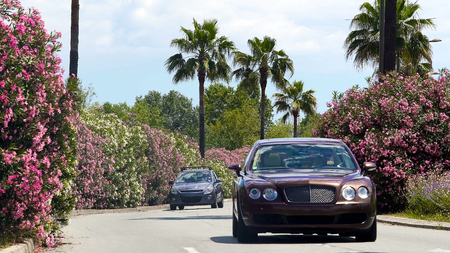 Expensive automobile on roadway, driver enjoying car trip in resort town, stock footageの写真素材
