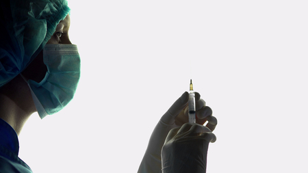 Nurse anesthetist with syringe in hand, injection before surgery, emergencyの写真素材