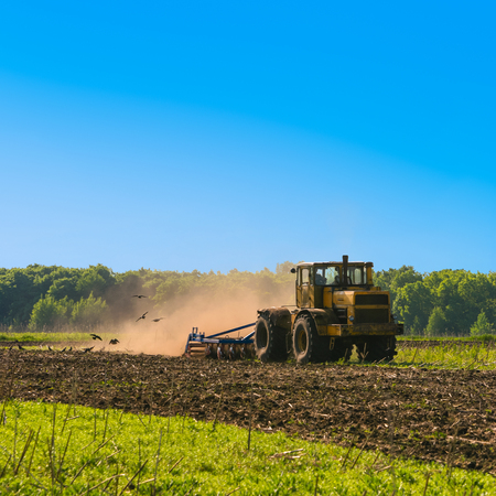 Tractor cultivating field at spring. Russian agricultureの写真素材