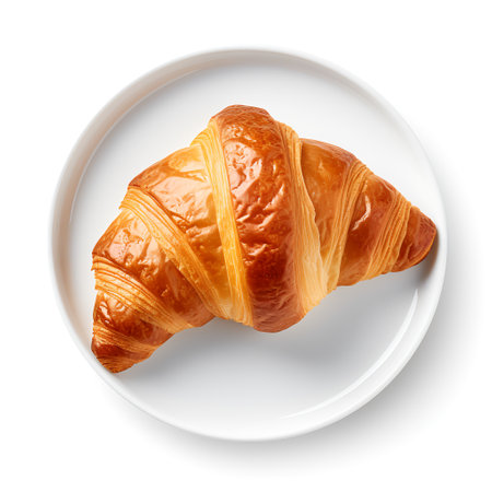 Croissant on plate isolated on white backgroundの素材