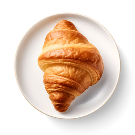 Croissant on plate isolated on white backgroundの素材