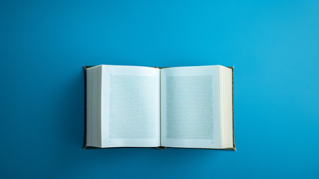 Open book on a blue background. Top view. Copy space.の素材