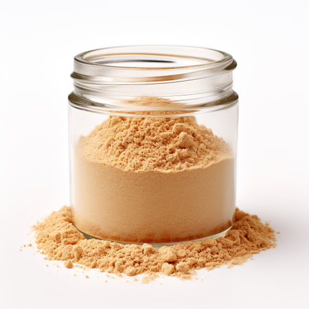 Photo of ginger powder in minimalist inside transparent jar isolated on white backgroundの素材