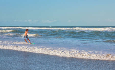 ocean wave rider at beach, SpaceCoast Florida の写真素材