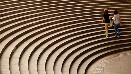 Arched stairs with two woman walking side by sideの写真素材