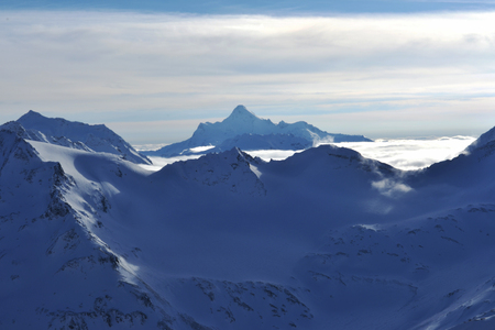 snow peaks, ridge, blue sky, floating clouds. beautiful view from ski slope.の写真素材