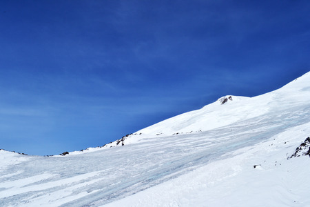 snow peaks, ridge, blue sky, floating clouds. beautiful view from ski slope.の写真素材