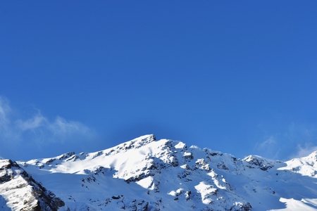 snow peaks, ridge, blue sky, floating clouds. beautiful view from ski slope.の写真素材