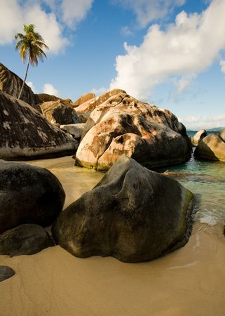 Massive boulders and crystal-clear waters on tropical islandの写真素材