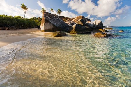 Massive boulders and crystal-clear waters on tropical islandの写真素材