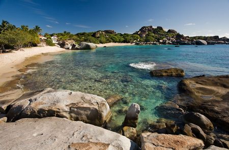 Massive boulders and crystal-clear waters on tropical islandの写真素材