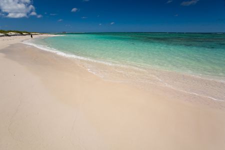 White sand beach and turquoise waters on tropical islandの写真素材