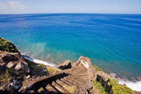 Steep stone stairway leading down to the ocean on tropical islandの写真素材