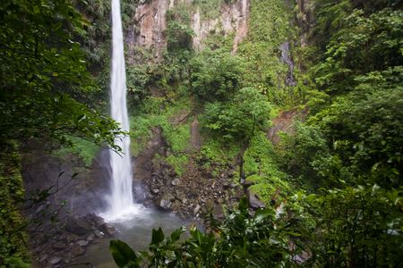 Spectacular waterfall and pool on lush tropical islandの写真素材