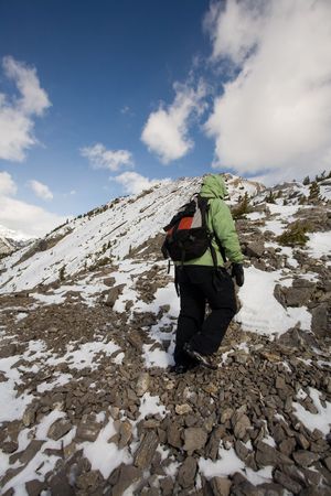 Young woman climbing a snowy mountain in the Canadian Rockiesの写真素材
