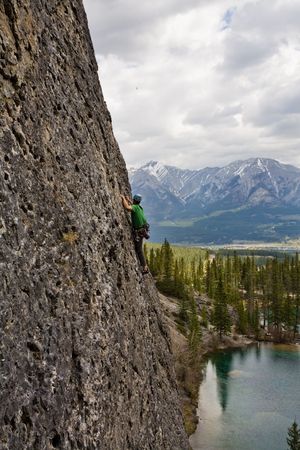 Rock climber high above lake in the Canadian Rockiesの写真素材