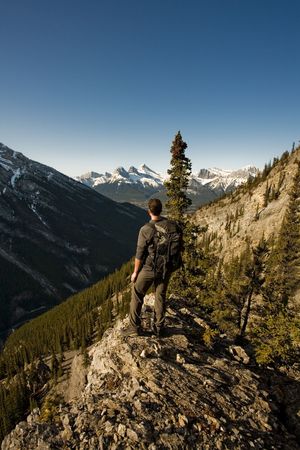 Young man exploring the Canadian Rocky Mountains in the Springの写真素材