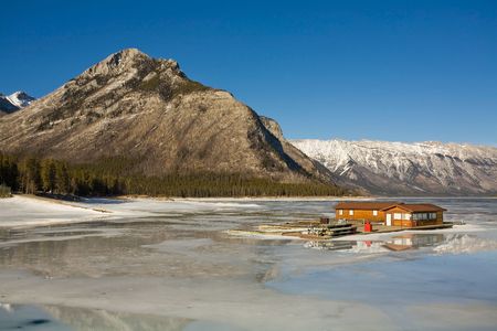 Log cabin on icy lake in the Canadian Rockiesの写真素材