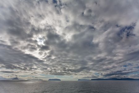 Dramtic clouds above the islands and ocean, Faroe Islands, Scandinaviaの写真素材