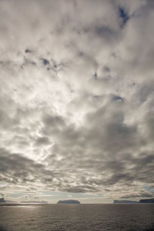 Dramtic clouds above the islands and ocean, Faroe Islands, Scandinaviaの写真素材