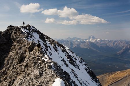 Climber reaches snowy summit in the Rocky Mountains, Kananaskis Country, Alberta, Canada.の写真素材