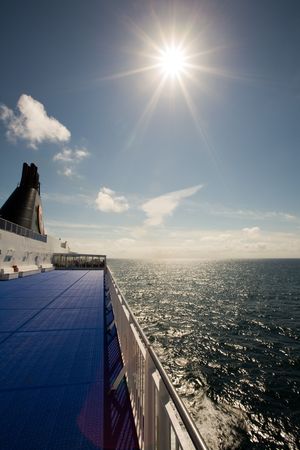 Sun shining in blue sky from deck of cruise ship, Norway, Scandinaviaの写真素材