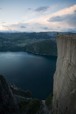 Silhouette of preson standing at the edge of immense cliff, high above the water, Lysefjord, Norway, Scandinaviaの写真素材