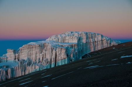 The early morning sun beginning to appear on the glaciers on the crater rim of Kilimanjaroの写真素材