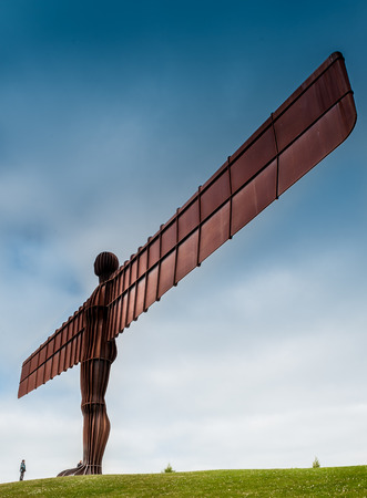 Standing 20 meters tall and located in Gateshead, UK  the Angel dominates the skyline, dwarfing all those who come to see it   Made from 200 tonnes of steel, it has a wingspan of 54 metres の写真素材