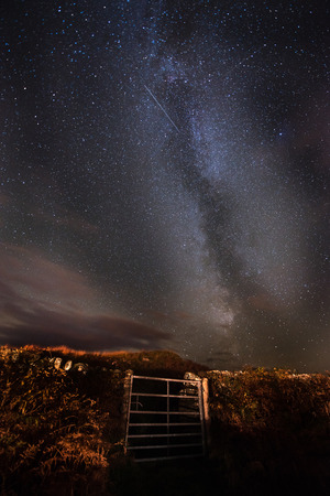 The Milky Way and Orionid Meteor shower over the night skies above the Dark Skies Park in Galloway, Scotlandの写真素材
