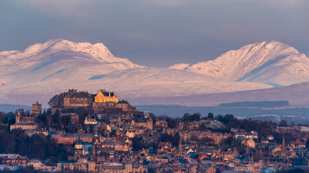 The early morning light on Stirling castle and wintery hills beyondの写真素材