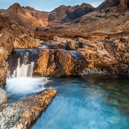 Located in Glen Brittle on the Isle of Skye lies the Fairy Pools a popular tourist attraction with the Cuillin Ridge in the backgroundの写真素材