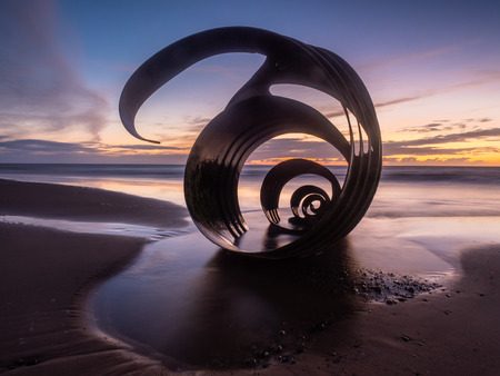 Sunset at the beach at Cleveleys on the Lancashire Coast with the artwork Mary's Shell  in the...