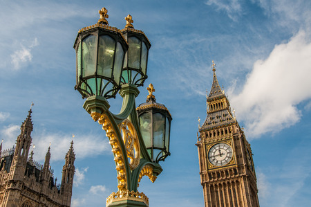 The Houses of Parliament and Big Ben with ornate street lamps on the Westminster Bridge in London in foreground.のeditorial素材