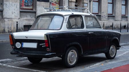 Old East German car, Trabant, sitting on a street in Budapest. It was the most common vehicle in East Germany, and was also exported to countries both inside and outside the former eastern blocの写真素材