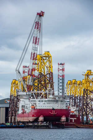"Seajacks Scylla" is the worlds most advanced offshore wind farm installation vessel. Loading foundation tripods in Cromarty Firthの写真素材