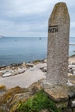 A stone marker for a coastal path along the shoreline on the South coast of Englandの写真素材