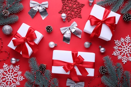 Christmas gifts presents with decorations on a red background.